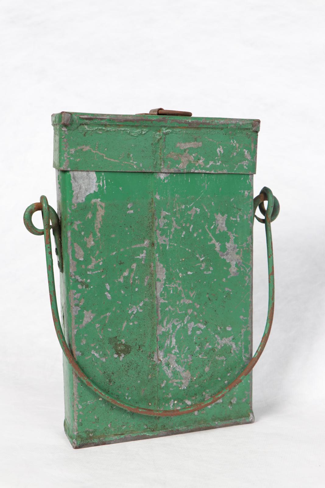 Green rectangular tin box with lid and wire handle.