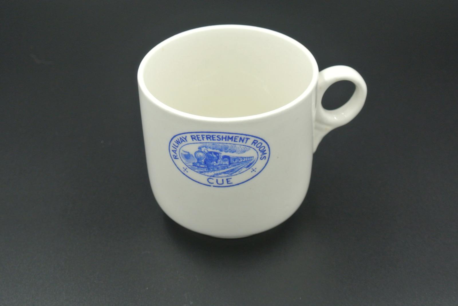 White cup with blue crest on facing side