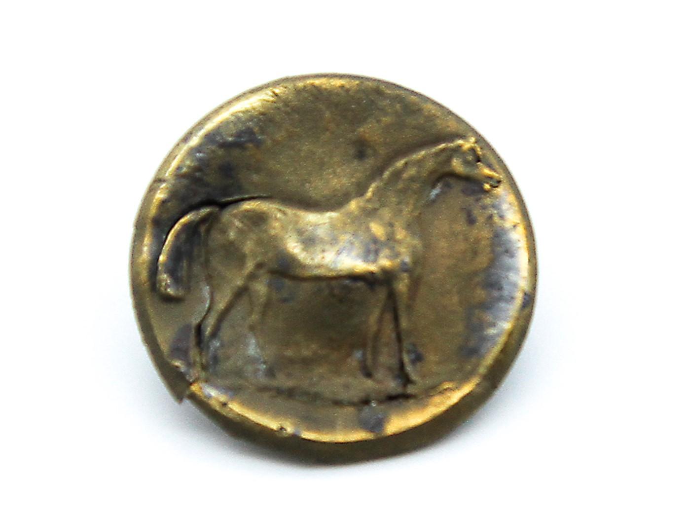 Brass button with horse motif