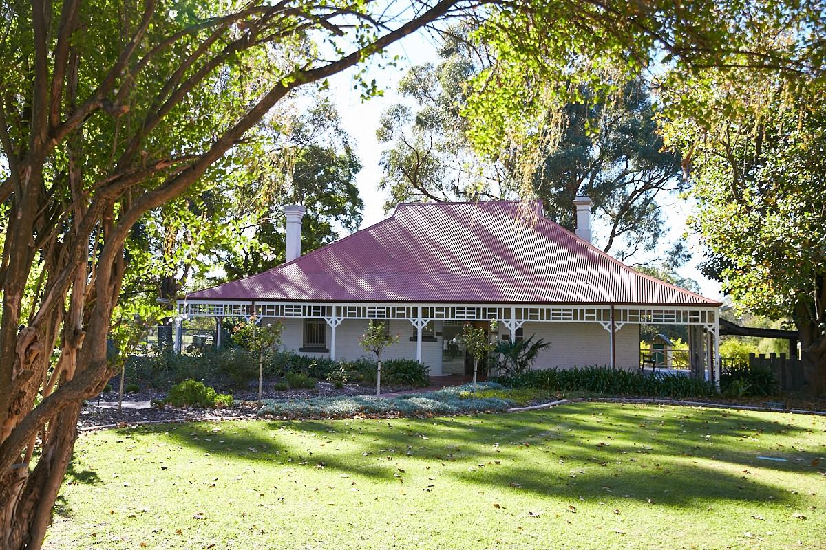 Front view of Wilkinson Homestead in landscaped gardens