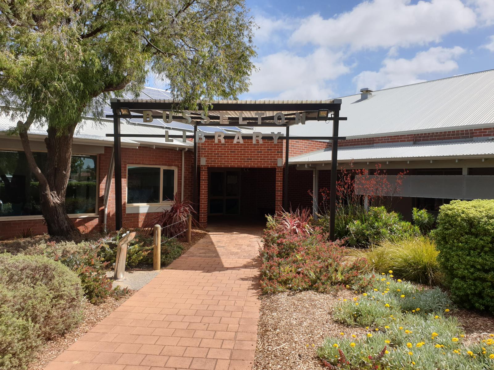 Garden, library sign and front entrance to the library