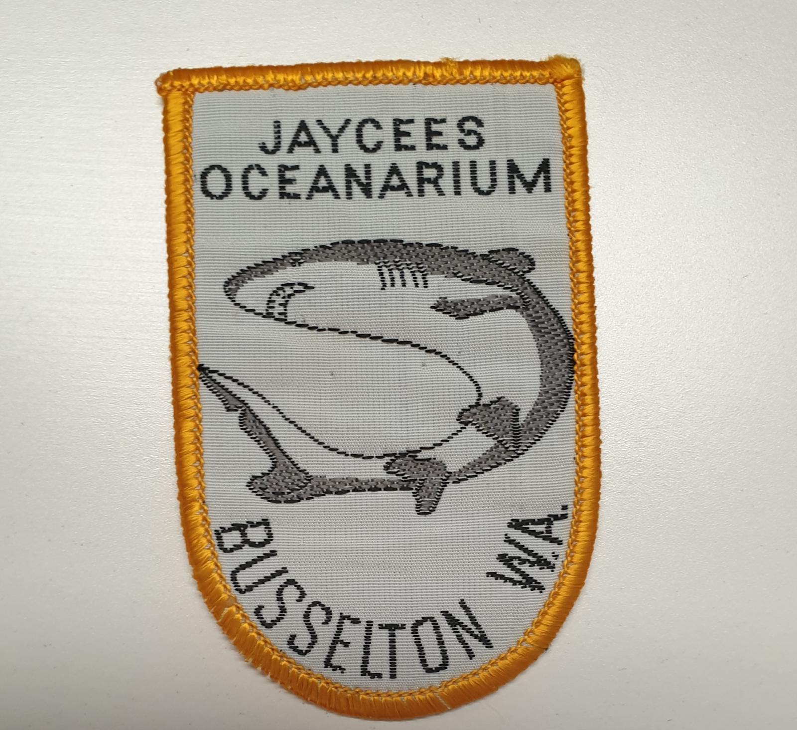 embroided badge souvenir from Jaycees Oceanarium. There is a yellow border with a shark in the middle. The worlds :Jaycees Oceanarium Busselton W.A. appear above and below the shark. 