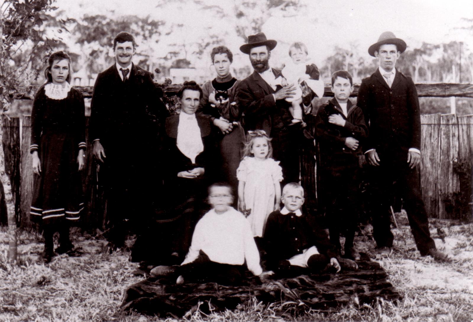 Peacock Family outside their home built in 18892