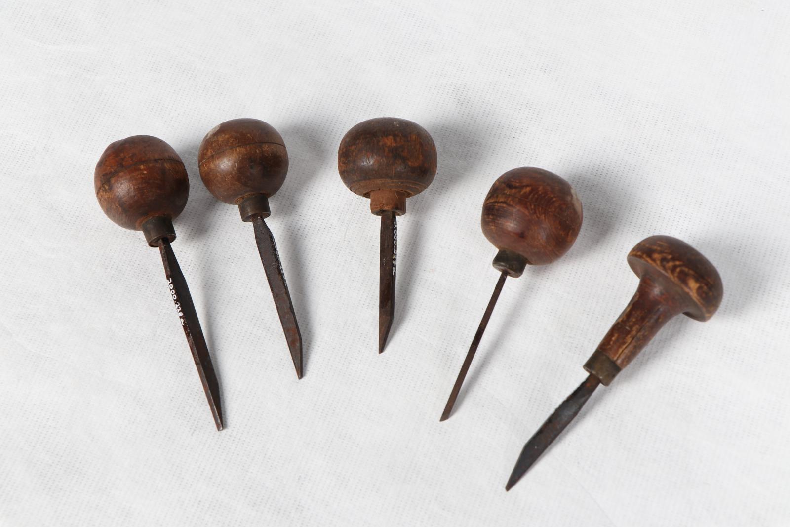 Five knives with wooden handles against a white background.