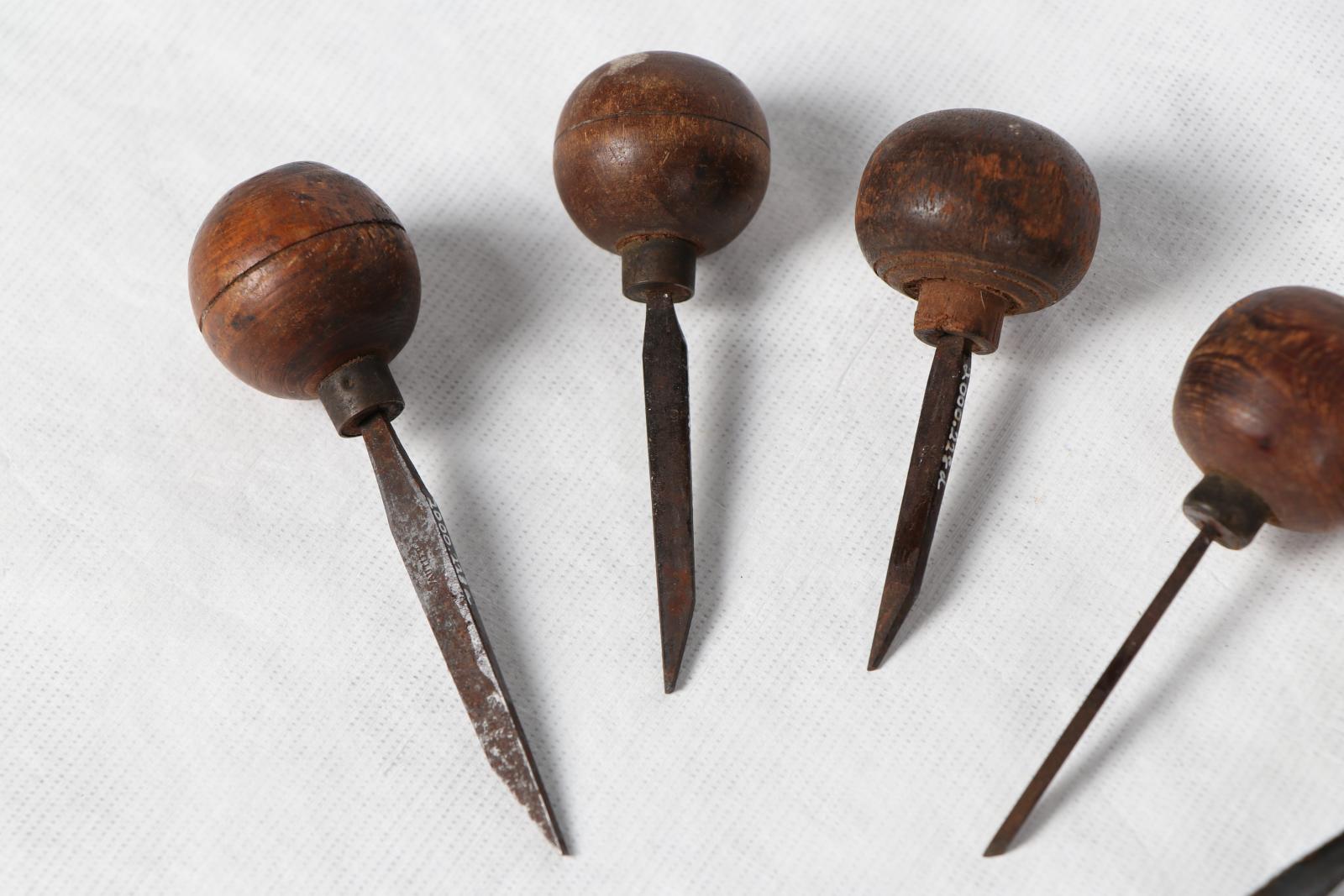 Close up of knives with wooden handles.