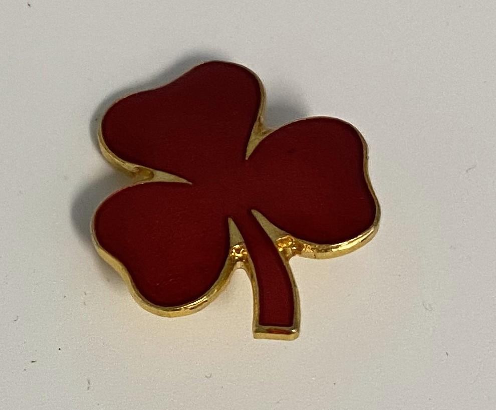 Red clover leaf badge