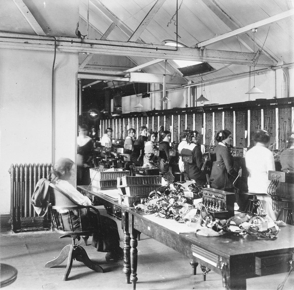 Black and white photograph of women sitting at telephone exchange