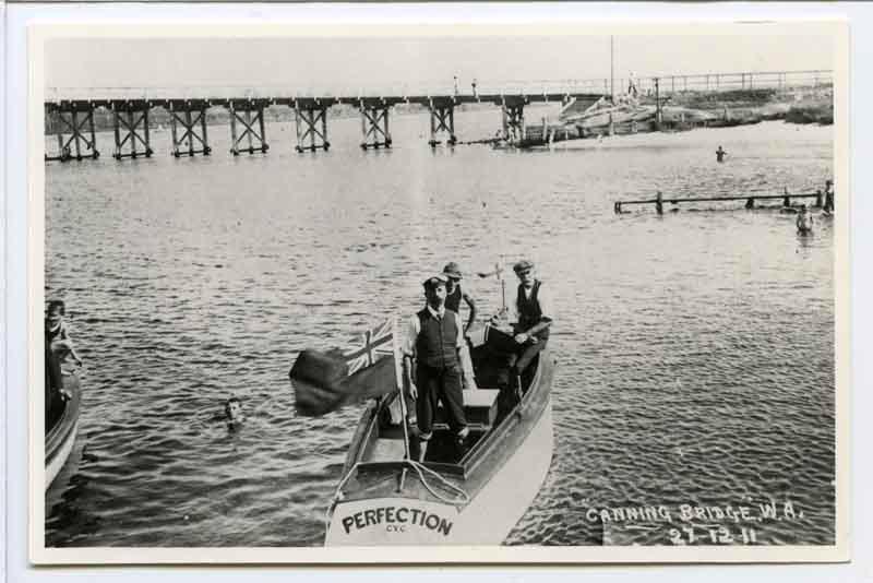 photograph of three men in a boat