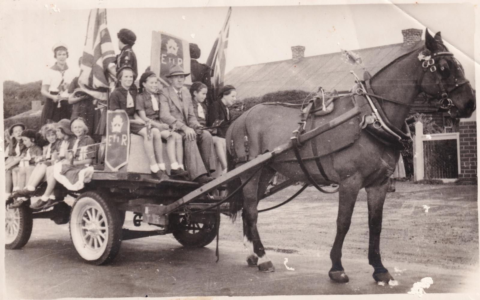 Jim Blain with Girl Guides in the wagon in Coronation Parade 1954