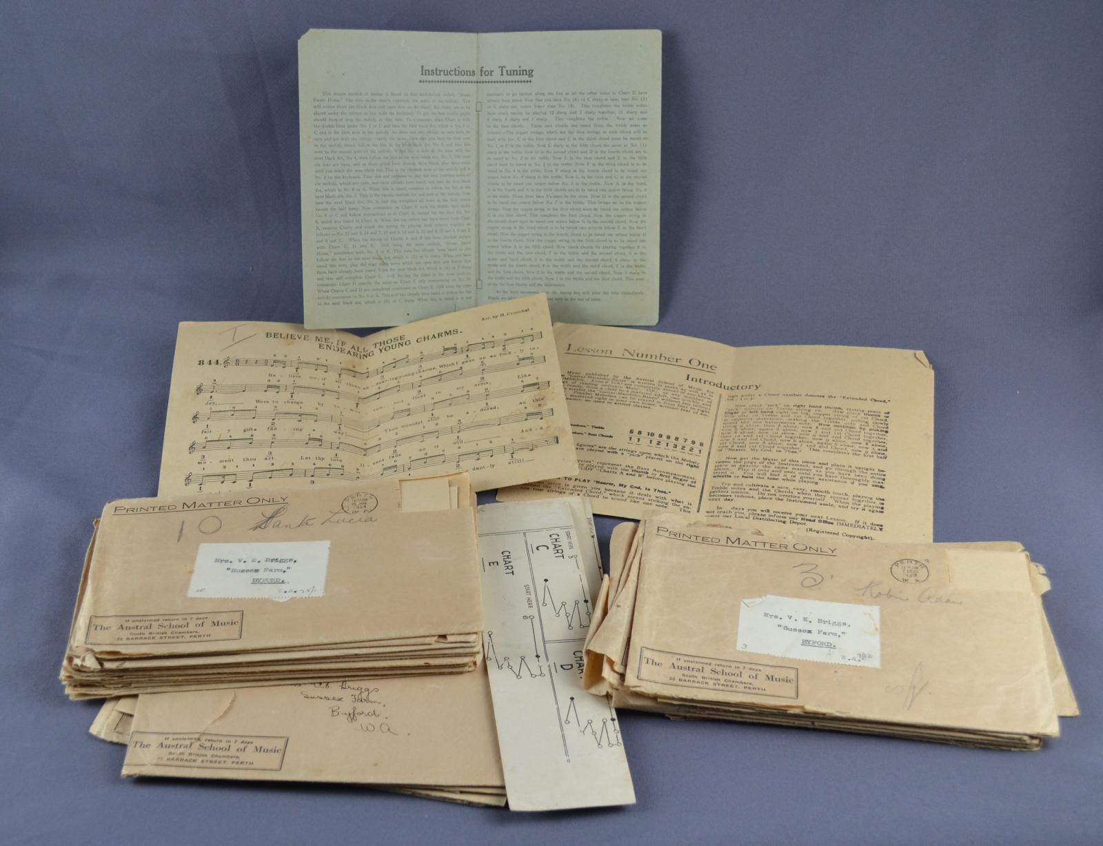 selection of tan coloured envelopes in two piles with open sheet music behind them