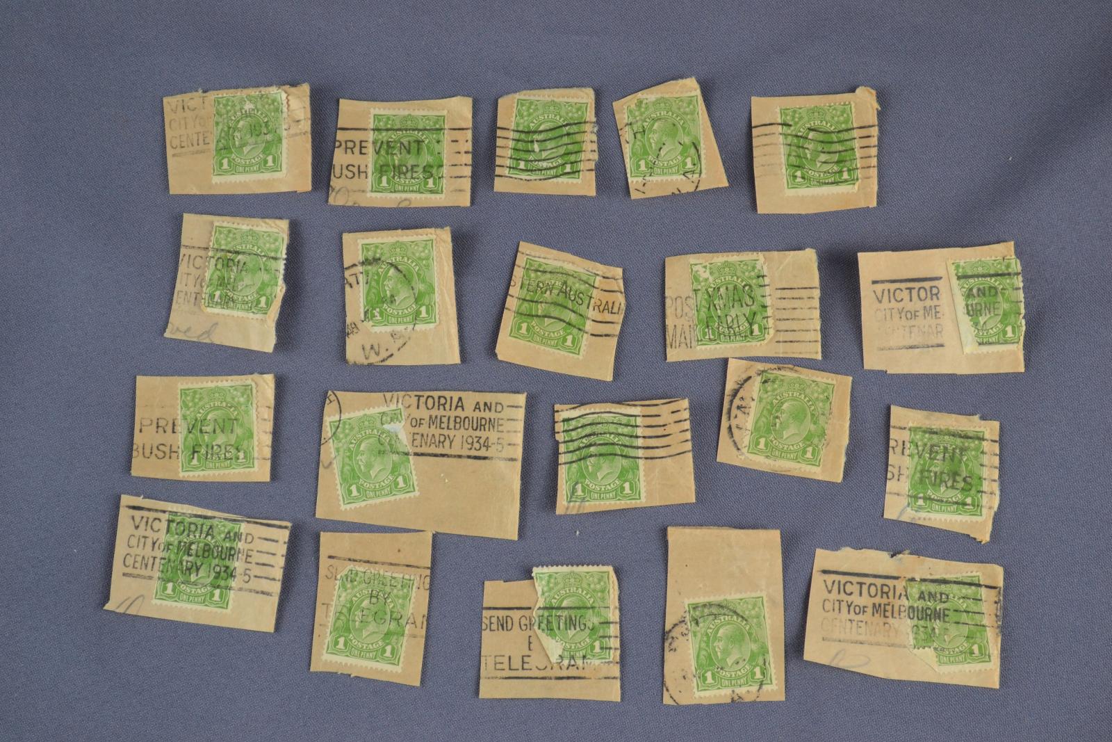 four rows of five tan paper squares with rectangle green stamps on them