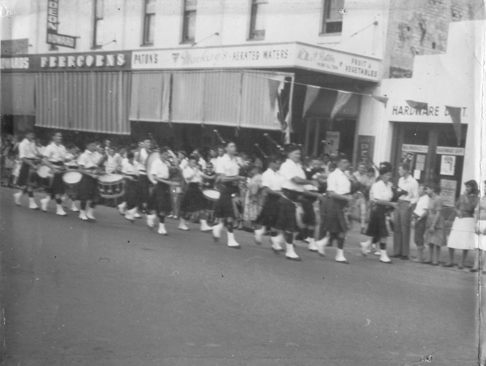 Pipe band marching down Helena Street, Midland.