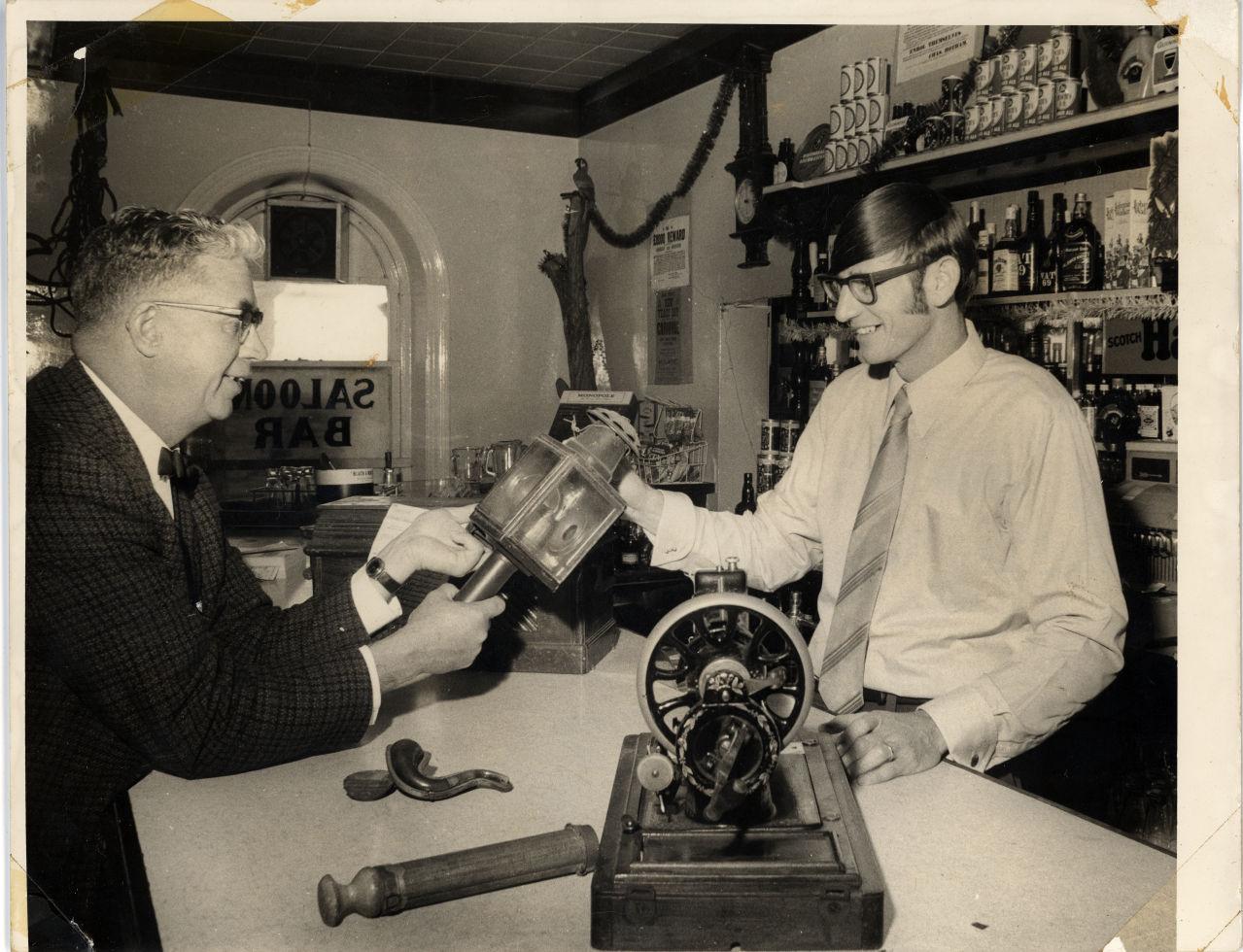 Two men saloon bar interior.