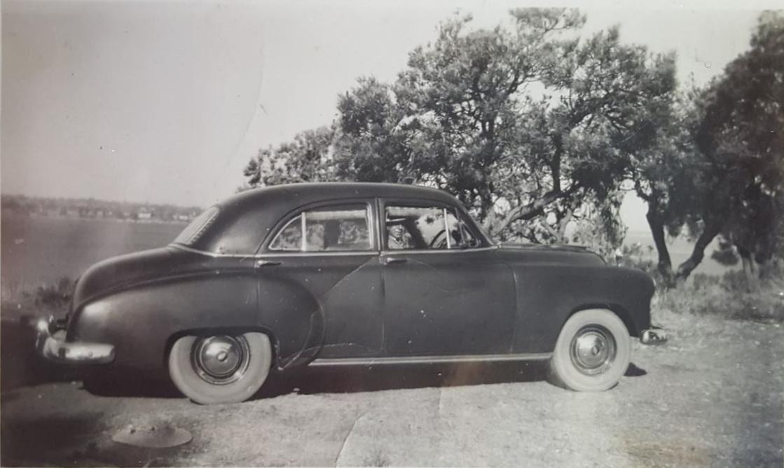 P25-05. Lew Whiteman driving his 1950 Chev, 1950s. Lew had a very large collection of vintage cars as well as horse-drawn coaches.