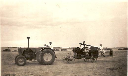 Photograph of a Fordson tractor pulling a baler at "Ironbarks Farm