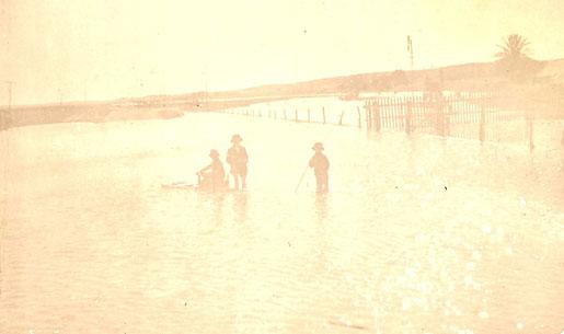 Photograph of children playing in flood waters