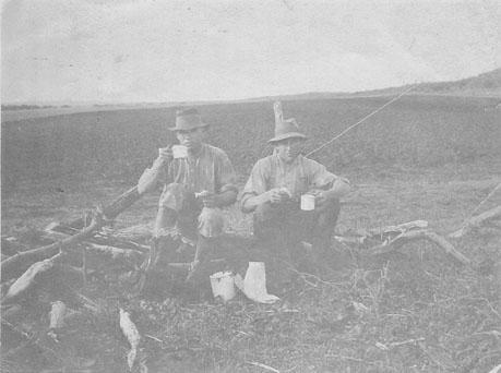 Photograph of two farm workers having smoko