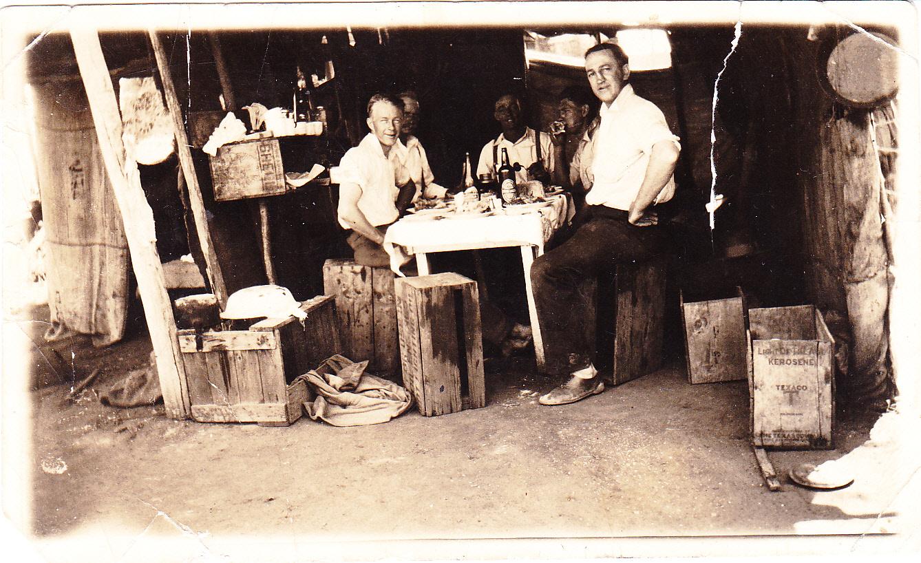 Photograph of men in a bush camp