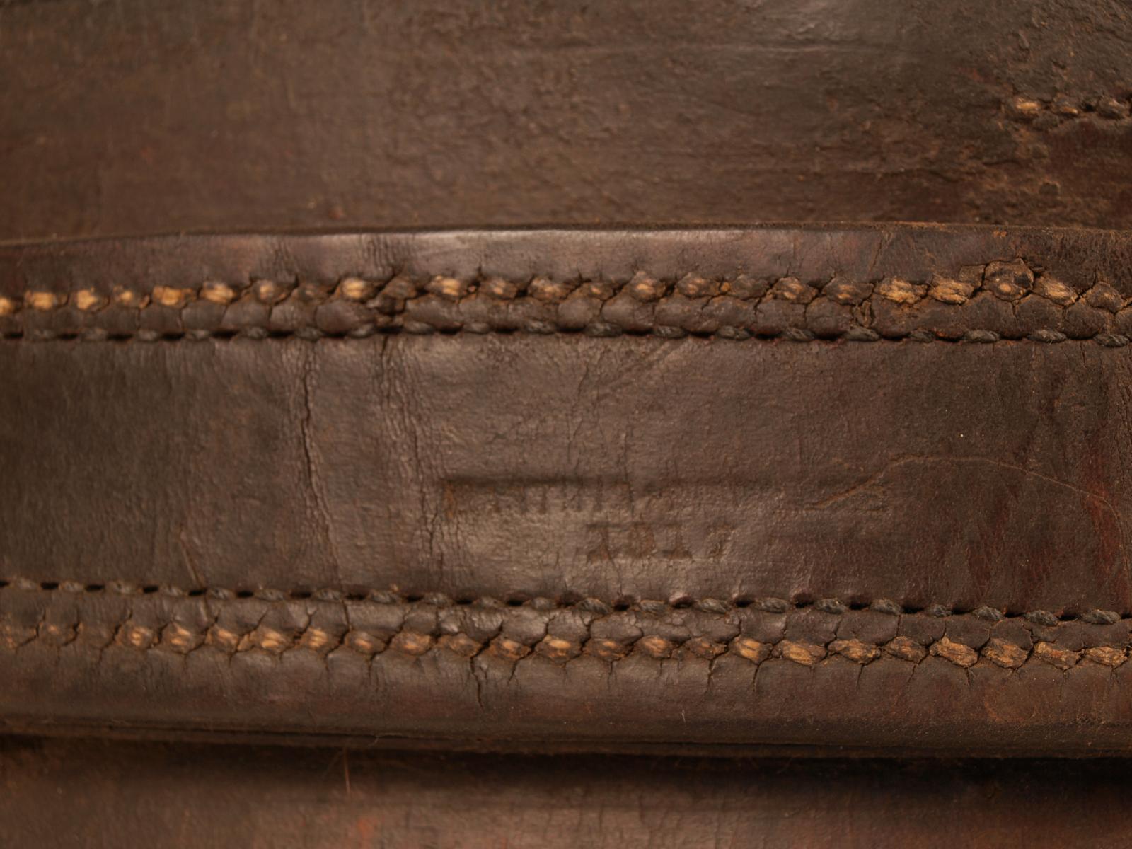 Closeup of makers mark stamped on brown leather horse collar. Legible part reads "Martins ... 1917"