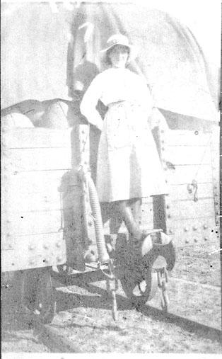 Ivy Morrell standing on rear of a loaded rail waggon