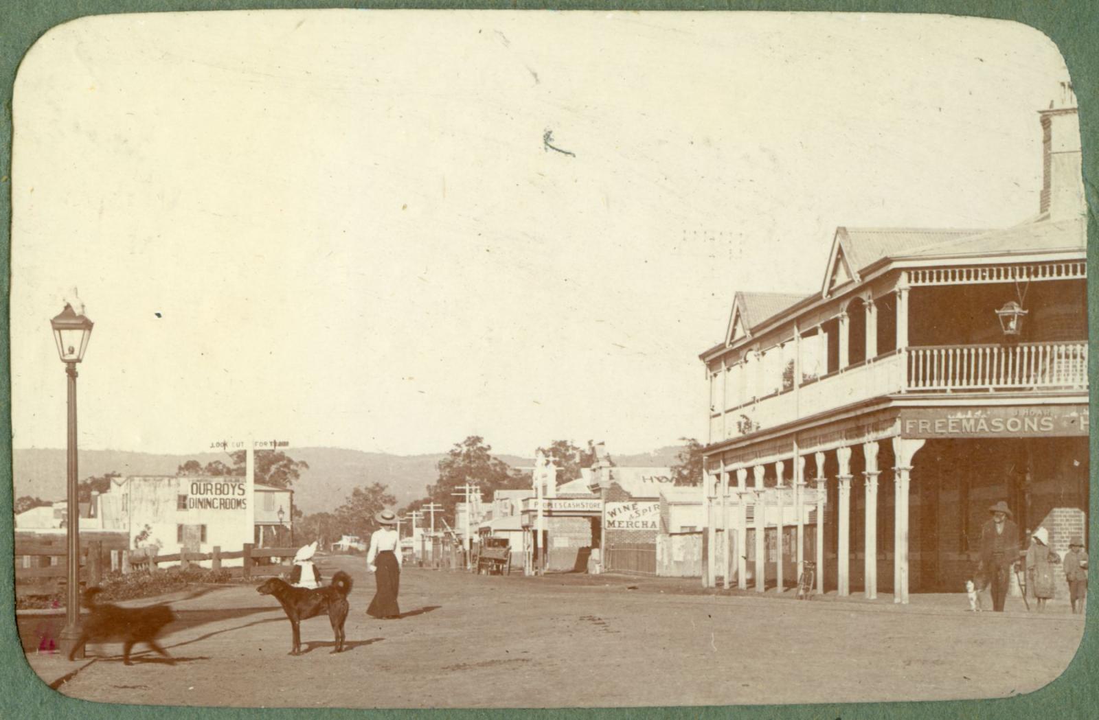 P100-12. York Road (Great Eastern Highway) at the junction of Helena Street. Perth Hills can be seen in the background and the Freemasons Hotel is on the right.