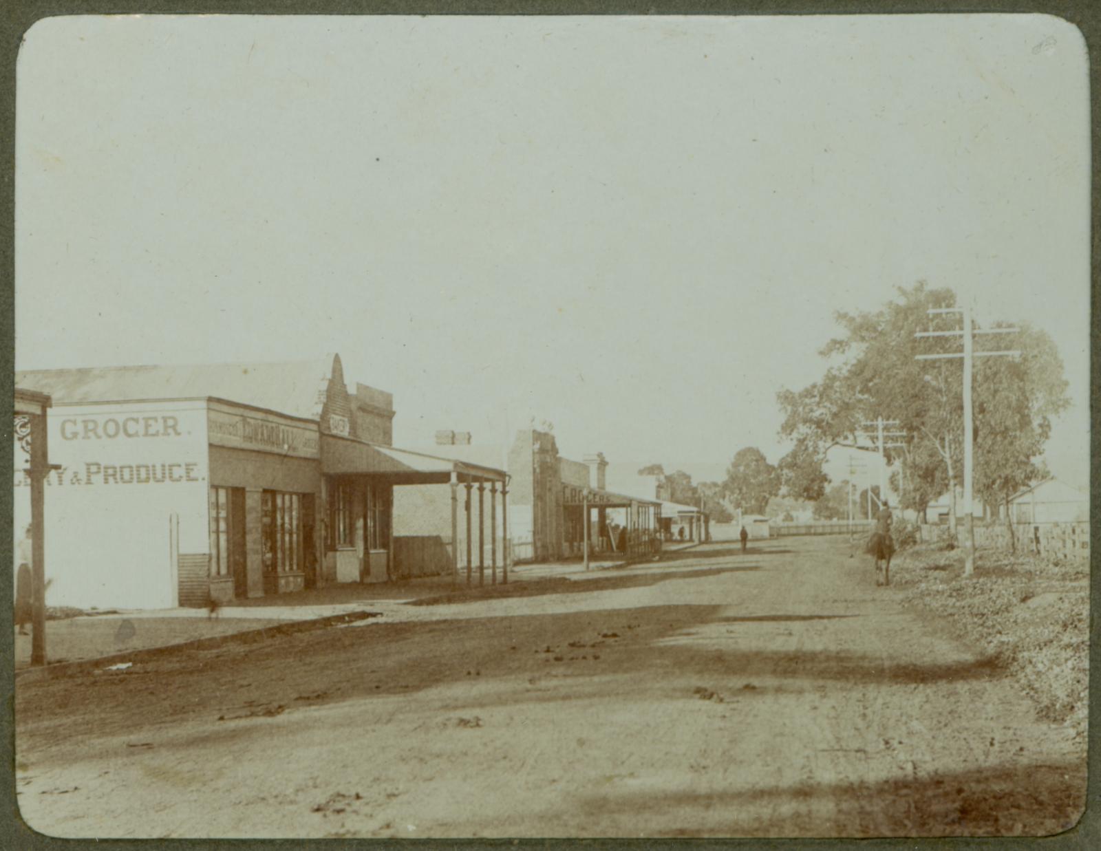 P100-14. Commercial Road (Great Eastern Highway), looking east towards Helena Street. On the left is Edward Hall's grocery store.