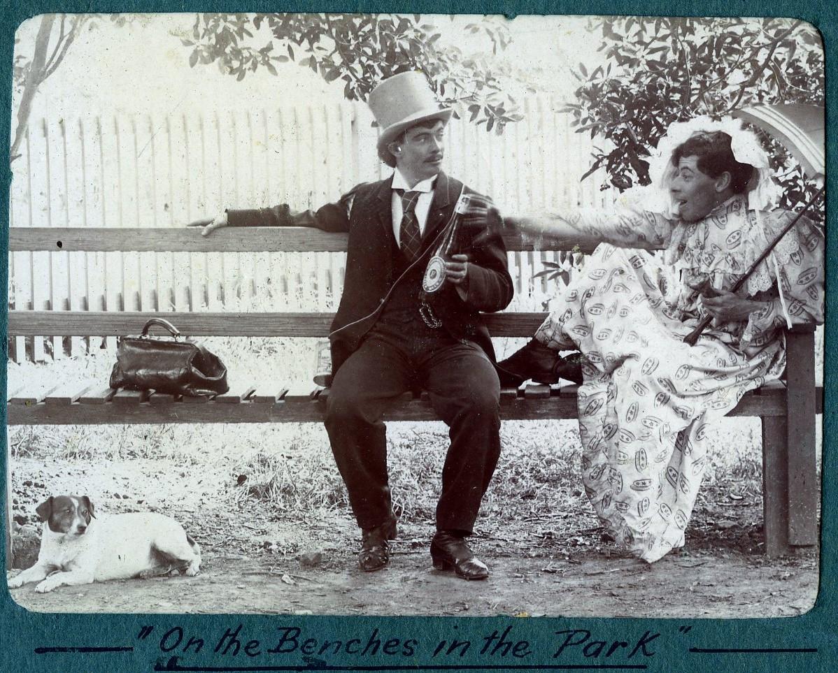 P100-36. William Dennis Dawson play-acting with an unknown man. Caption reads 'On the benches in the park'.