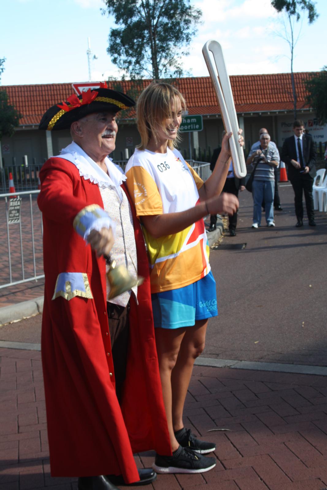 P97-13. Natalie Medhurst, the first relayer to leave Midland poses with the Town Cryer. 