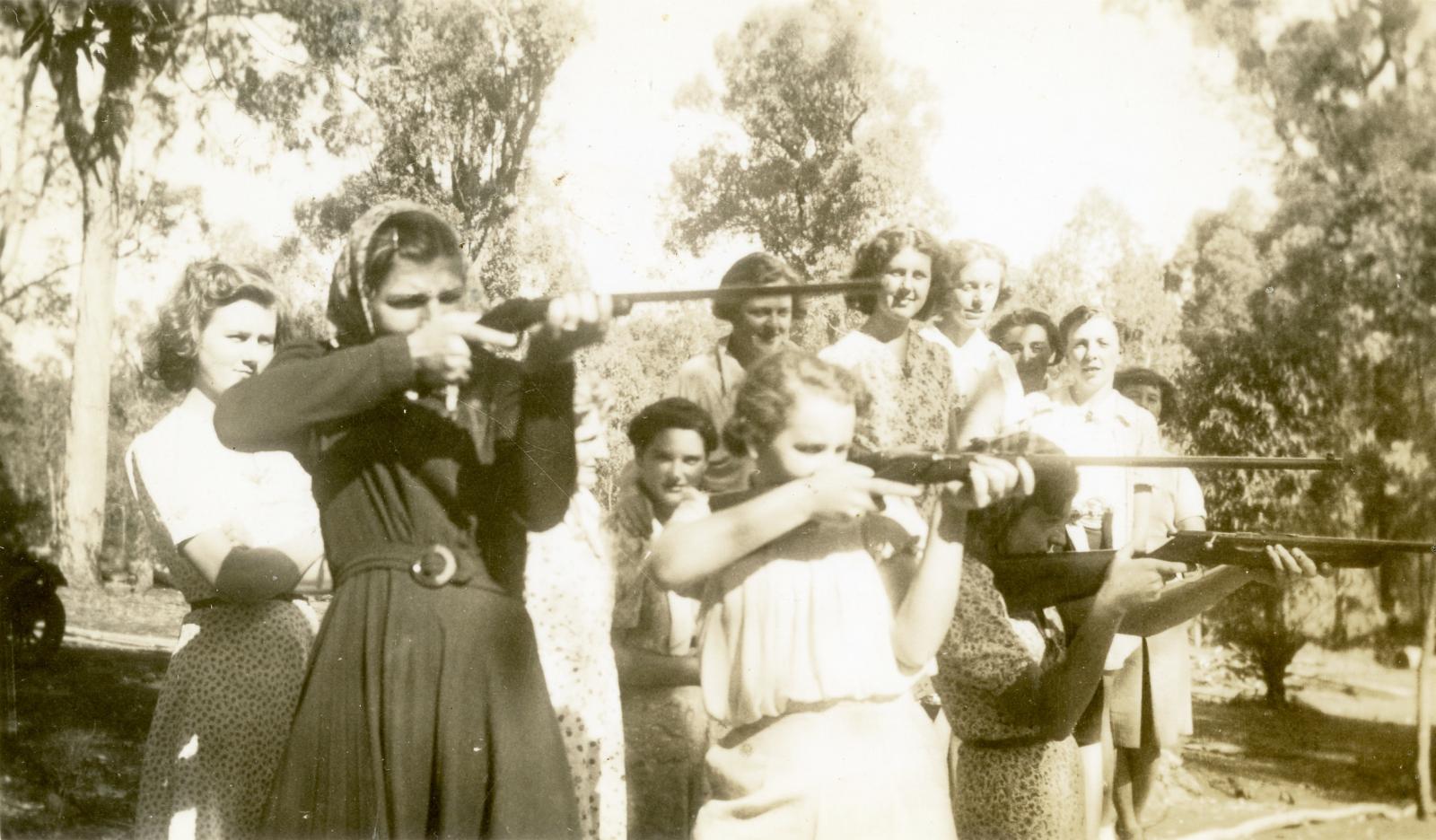 Members of the AWEC learning to fire a rifle.