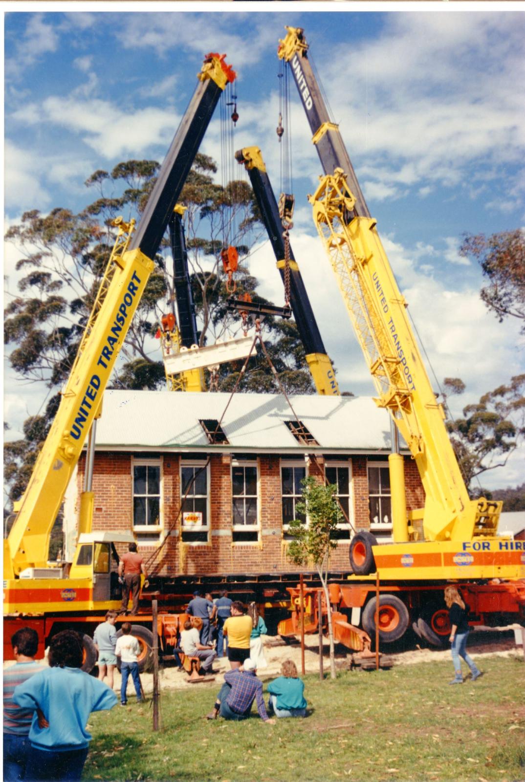 Cranes lifting the school on to its new footings at Minnawarra Park.