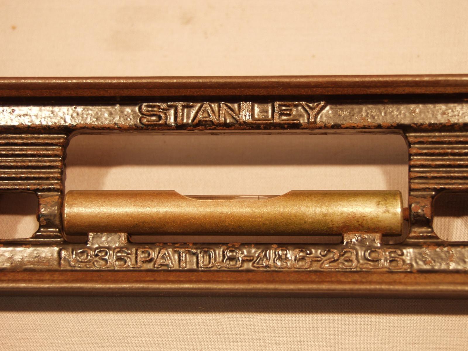 Macro view of the name Stanley in the centre of the spirit level. The view also shows the patent number of the spirit level