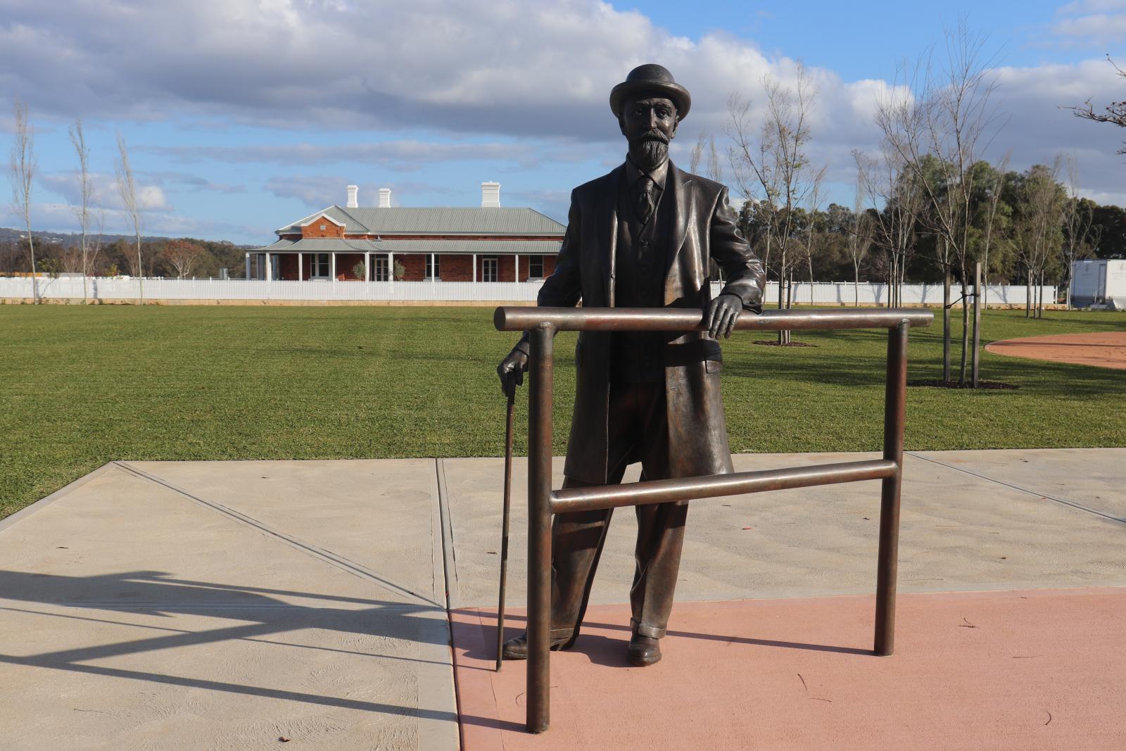 Grounds of the Robinson Grove Estate. Statue of Edward Robinson in the foreground. Restored Belle View homestead in the background.