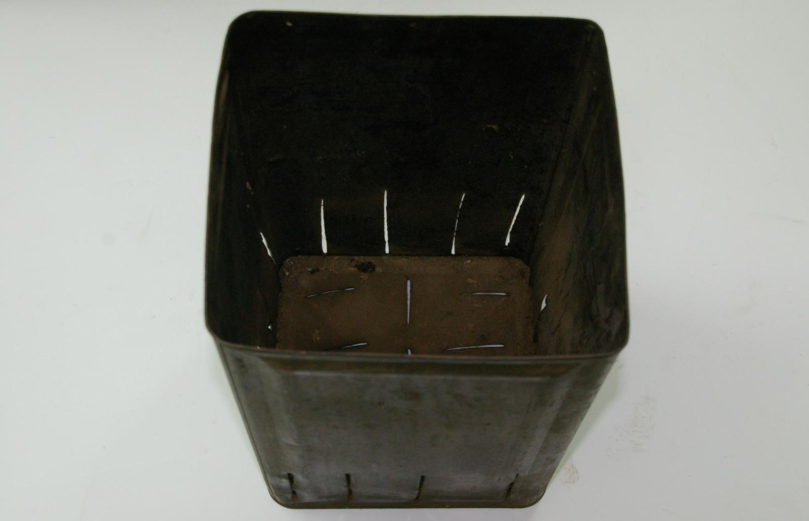 petrol tin with slots cut into base