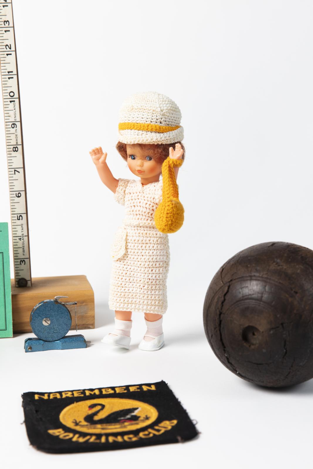 close up of doll, badge etc. from Narembeen Bowls Club Inc