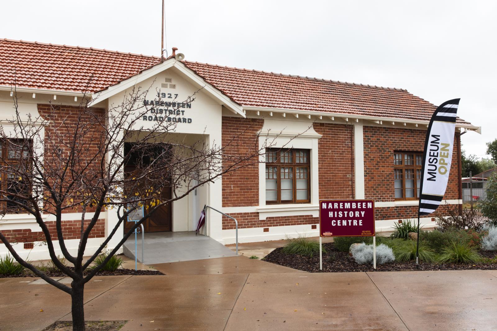 A mid 20th century building with a sign in front saying NAREMBEEN HISTORY CENTRE