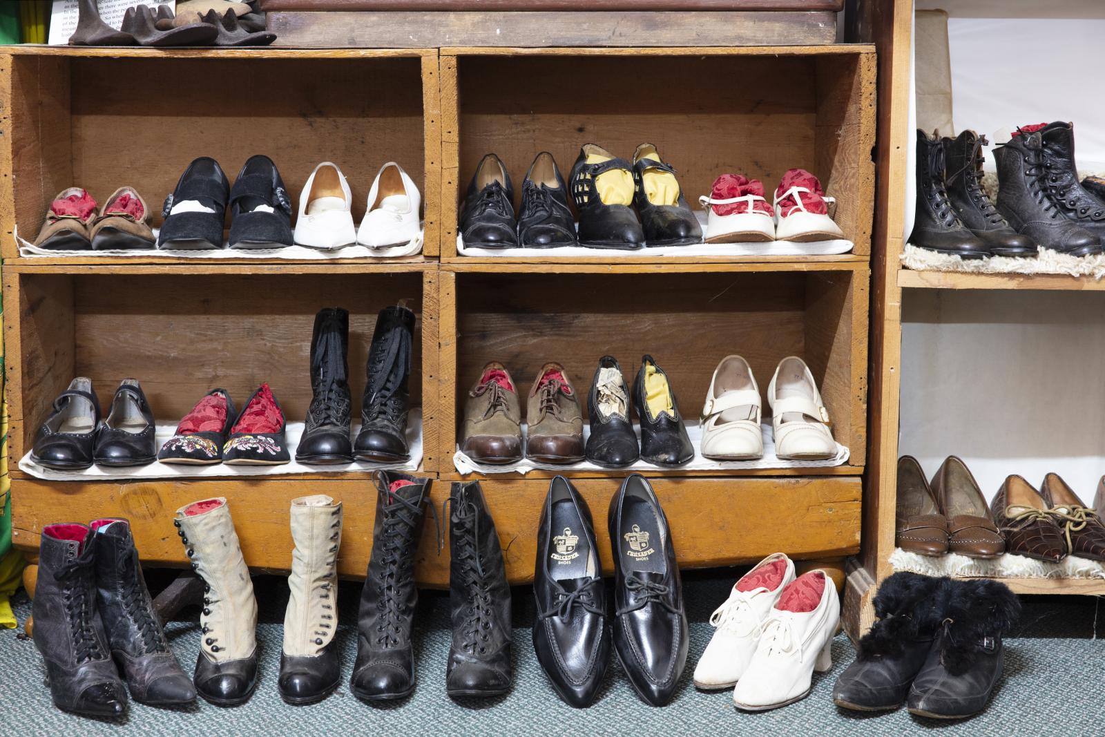 collection of shoes on wooden shelving