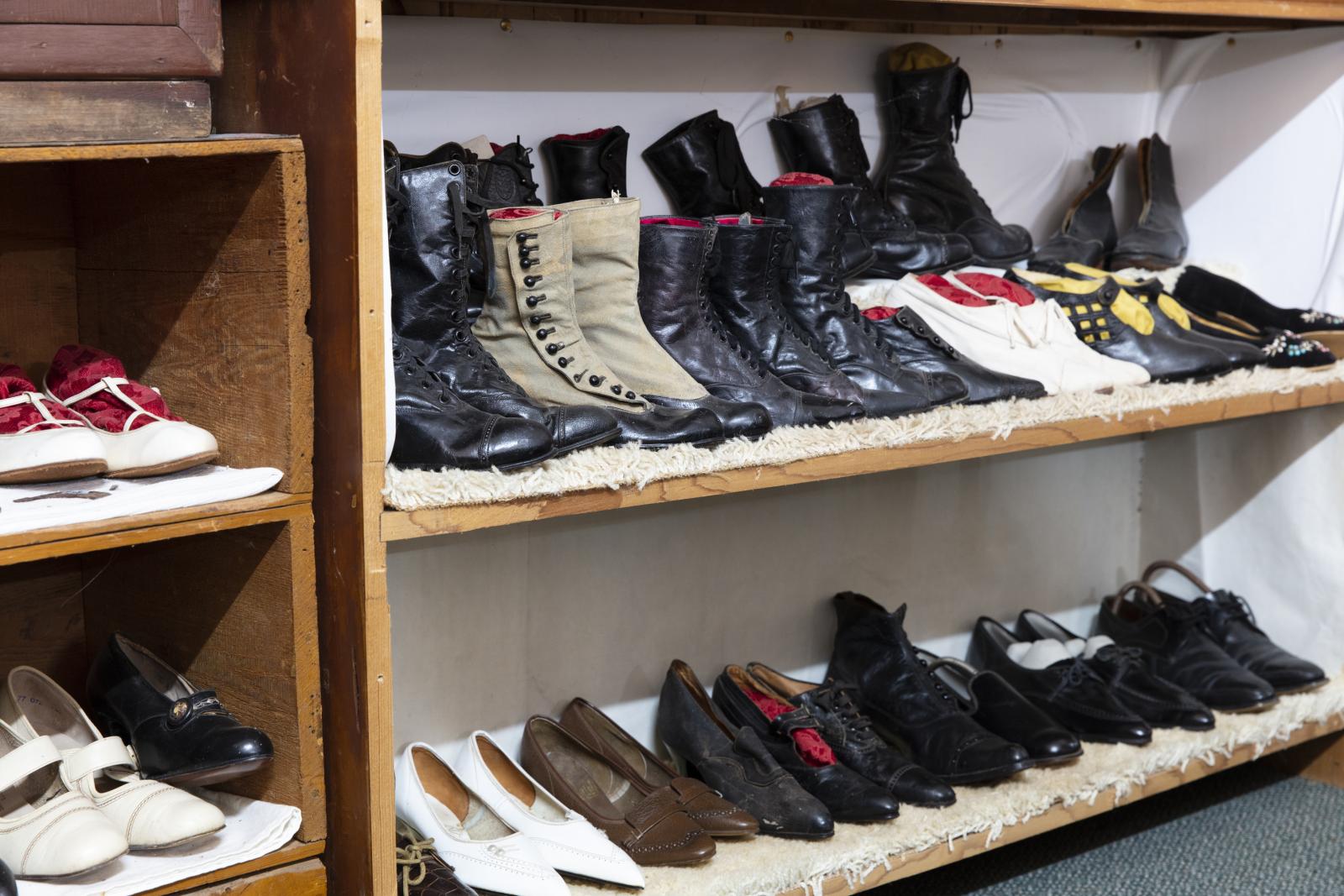 collection of shoes on wooden shelving