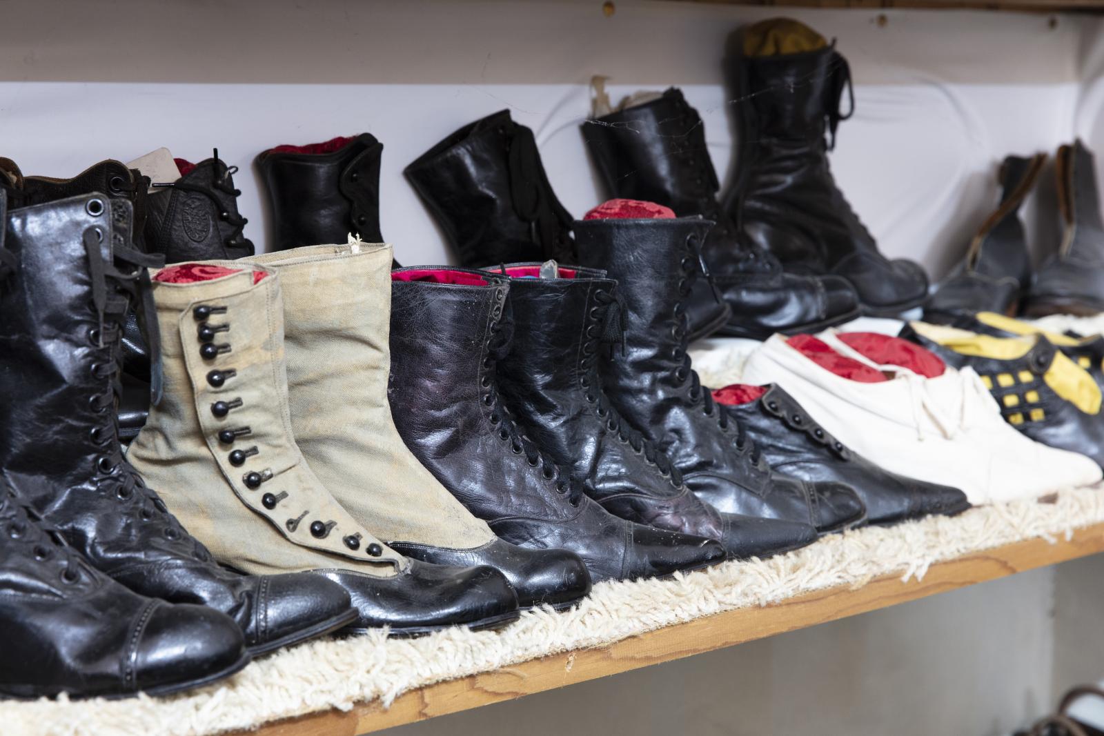 collection of shoes on wooden shelving