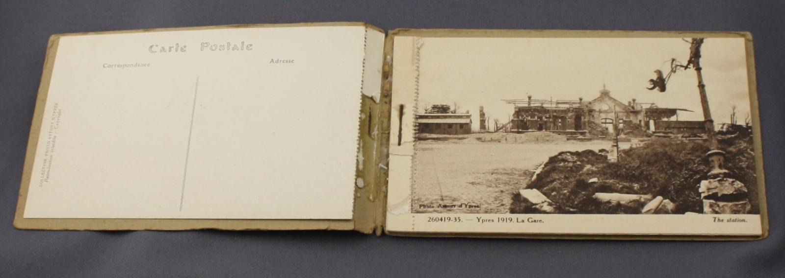 Book of 12 postcards of Ypres ruins after World War 1. The book is open to a photograph of Ypres 1919, La Gare.