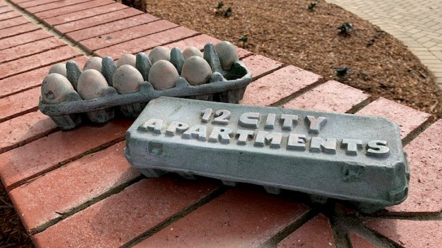 Two bronze egg cartons