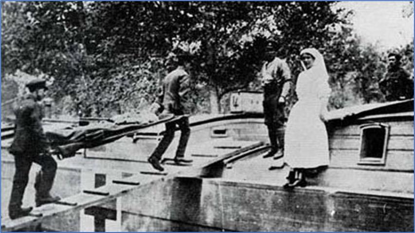 Wounded being loaded onto hospital transport barges.