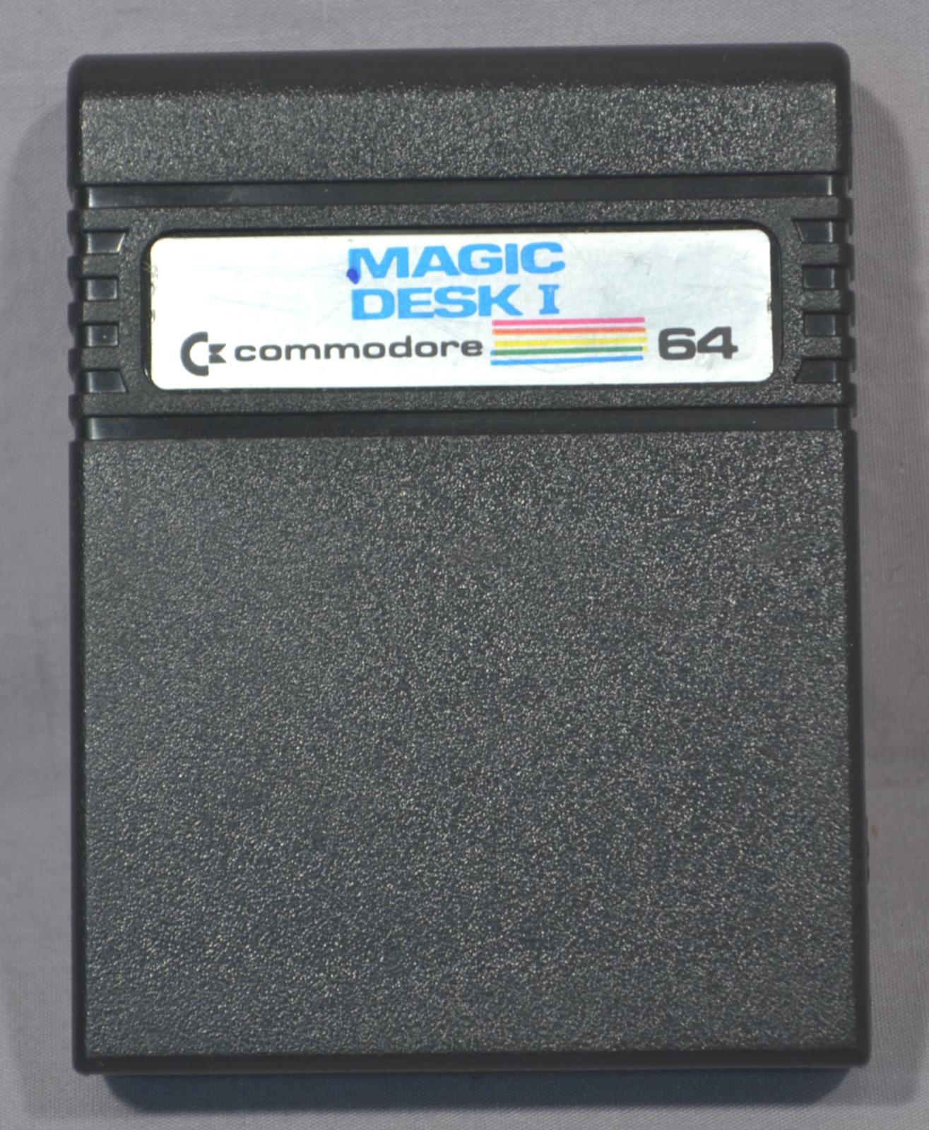 Black rectangular cartridge. Top edge is rounded with 5 ridges running around the cartridge near the top. On top of the ridges is a silver coloured label with blue text with the name of the program.