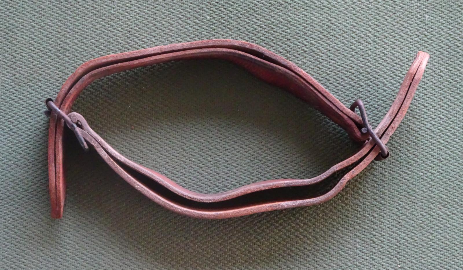 Top of leather straps buckled together to form a collar