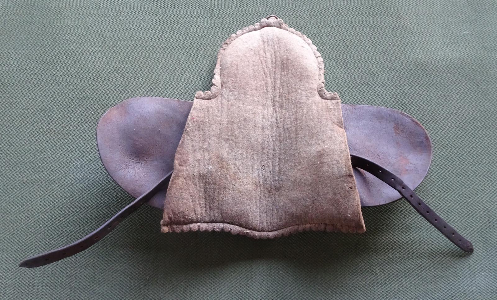 Underside of saddle that goes underneath cane chair for sitting on a bullock