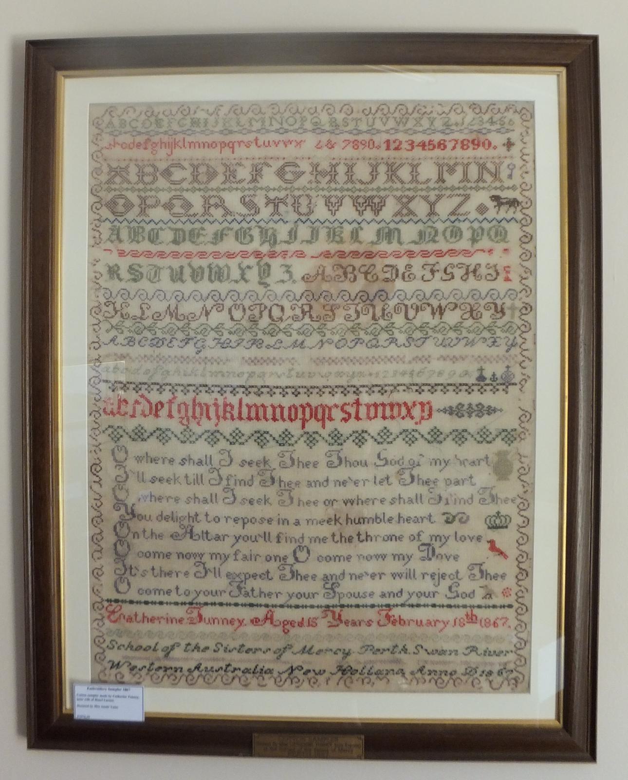 Framed embroidery sampler done by Catherine Tunney