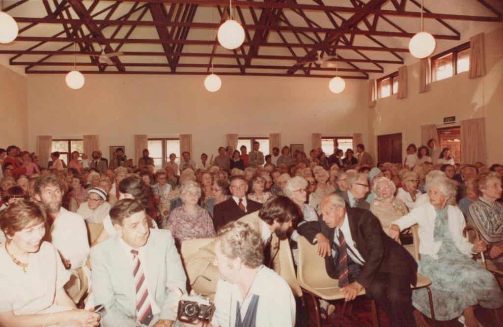 People sitting and standing in a large room