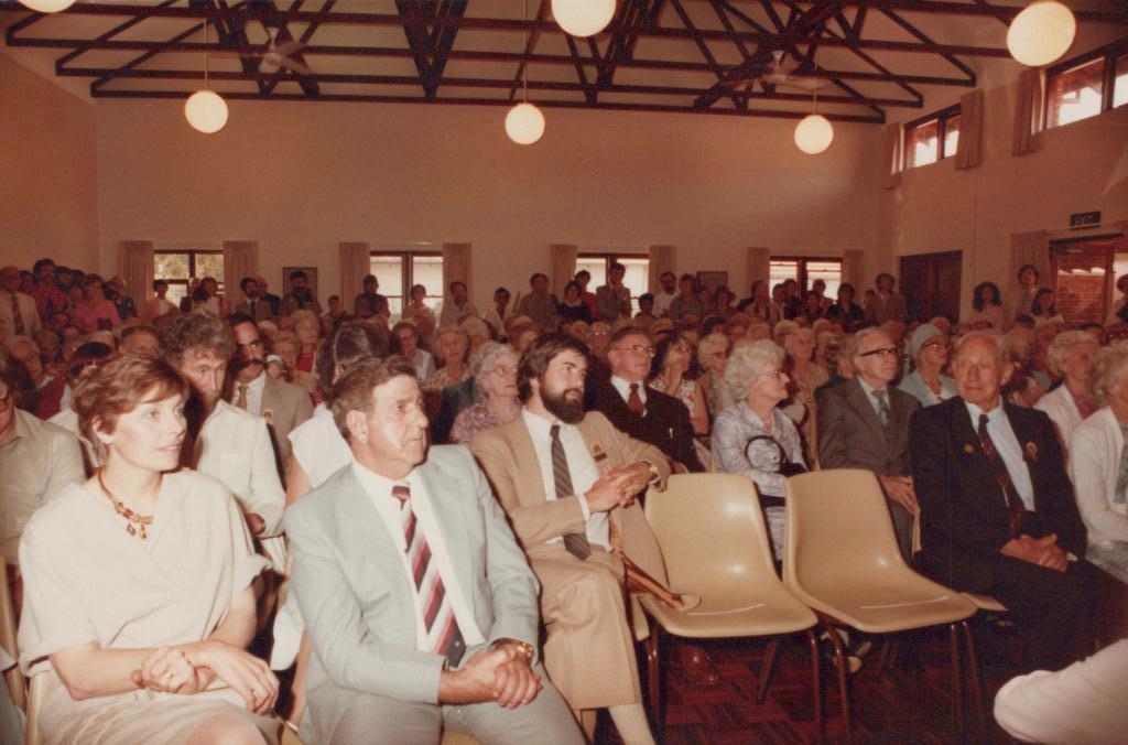 People sitting and standing in a large room