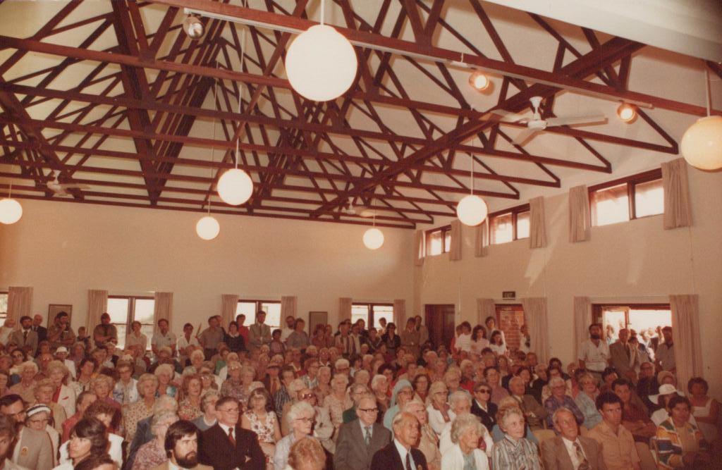 People sitting and standing in a large room