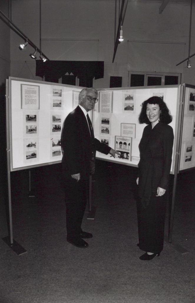 black and white photo of a man and woman standing and facing camera