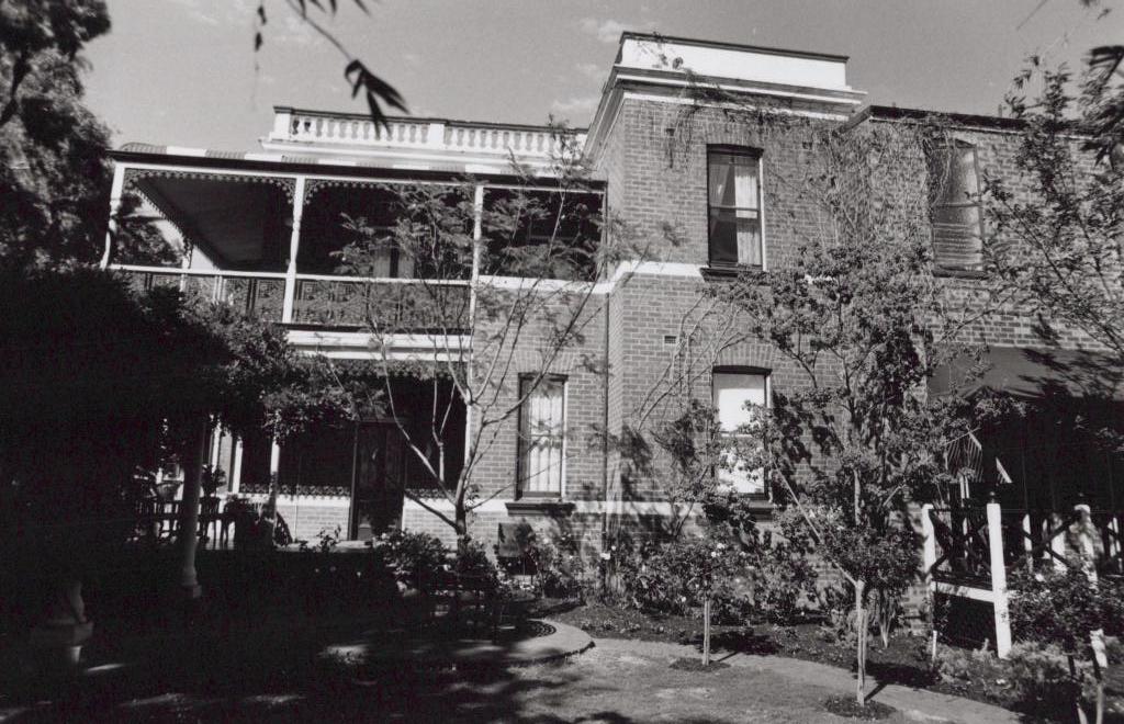 black and white photo of a multi story brick building